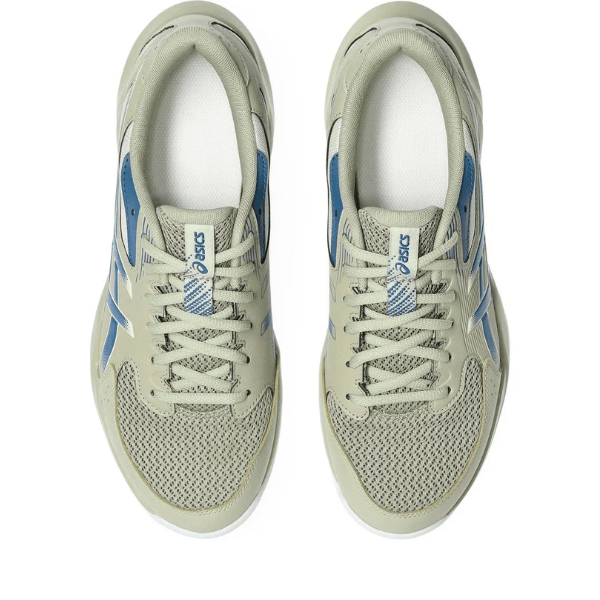 Pair of beige and blue Asics sneakers on a white background
