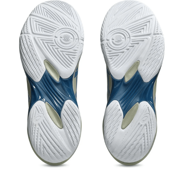 Close-up of blue and white athletic shoes with tread pattern on a white background