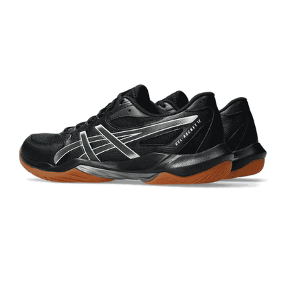 Black athletic shoe with orange sole on a white background