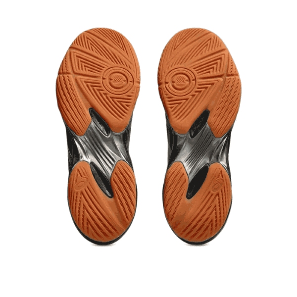 Close-up of orange and black athletic shoe soles on a white background