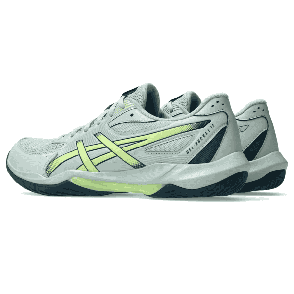White athletic shoes with green accents on a white background