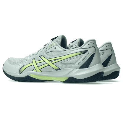 White athletic shoes with green accents on a white background