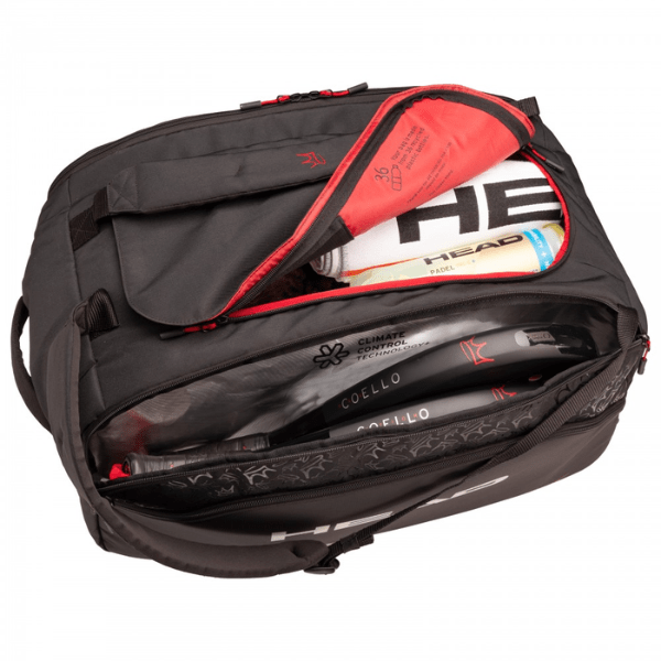 Open black tennis bag with rackets and equipment on a white background