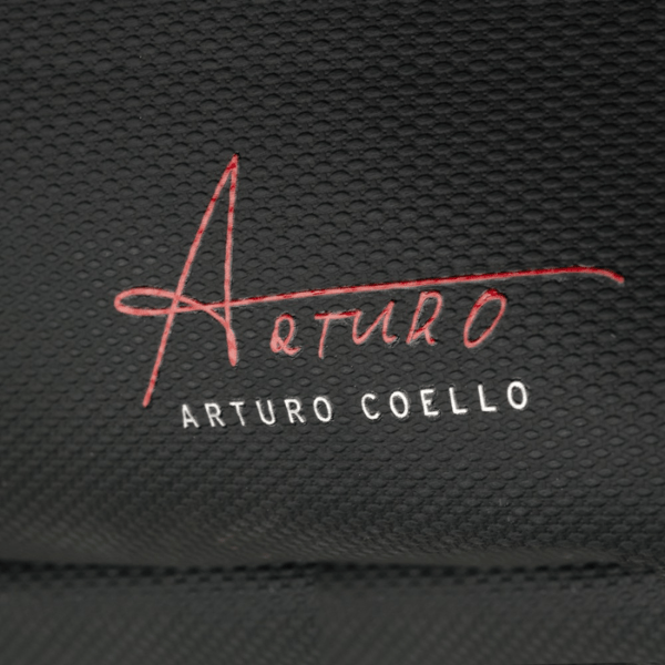 Embroidered signature and name on a textured black background