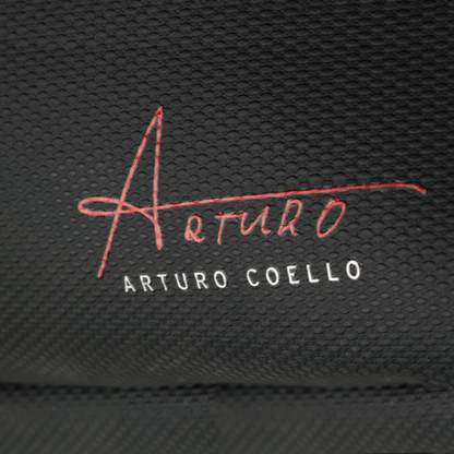 Embroidered signature and name on a textured black background
