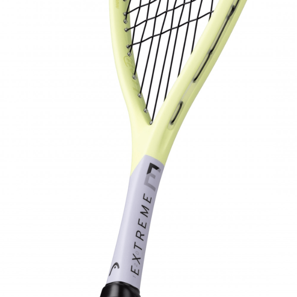 Close-up of a yellow squash racket with 'EXTREME' branding on a white background