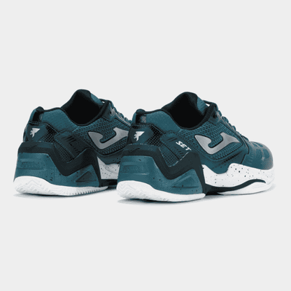 Pair of teal and black sneakers with white soles on a light gray background