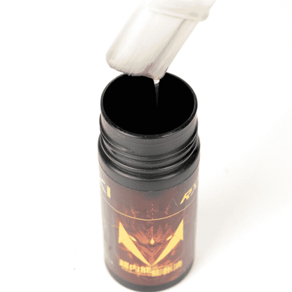 Black container with a white applicator on a white background