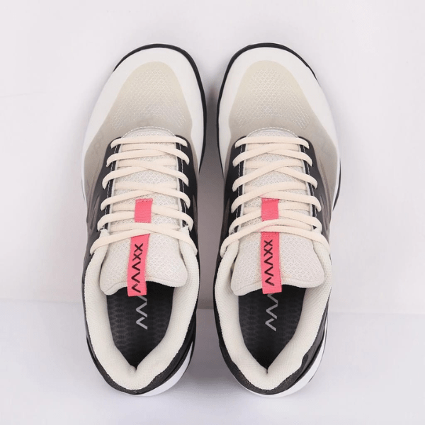 Pair of black and white sneakers with pink accents on a light gray background