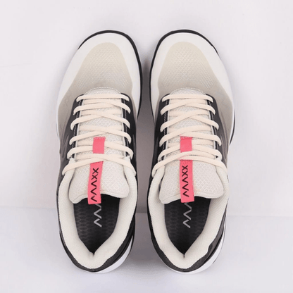 Pair of black and white sneakers with pink accents on a light gray background